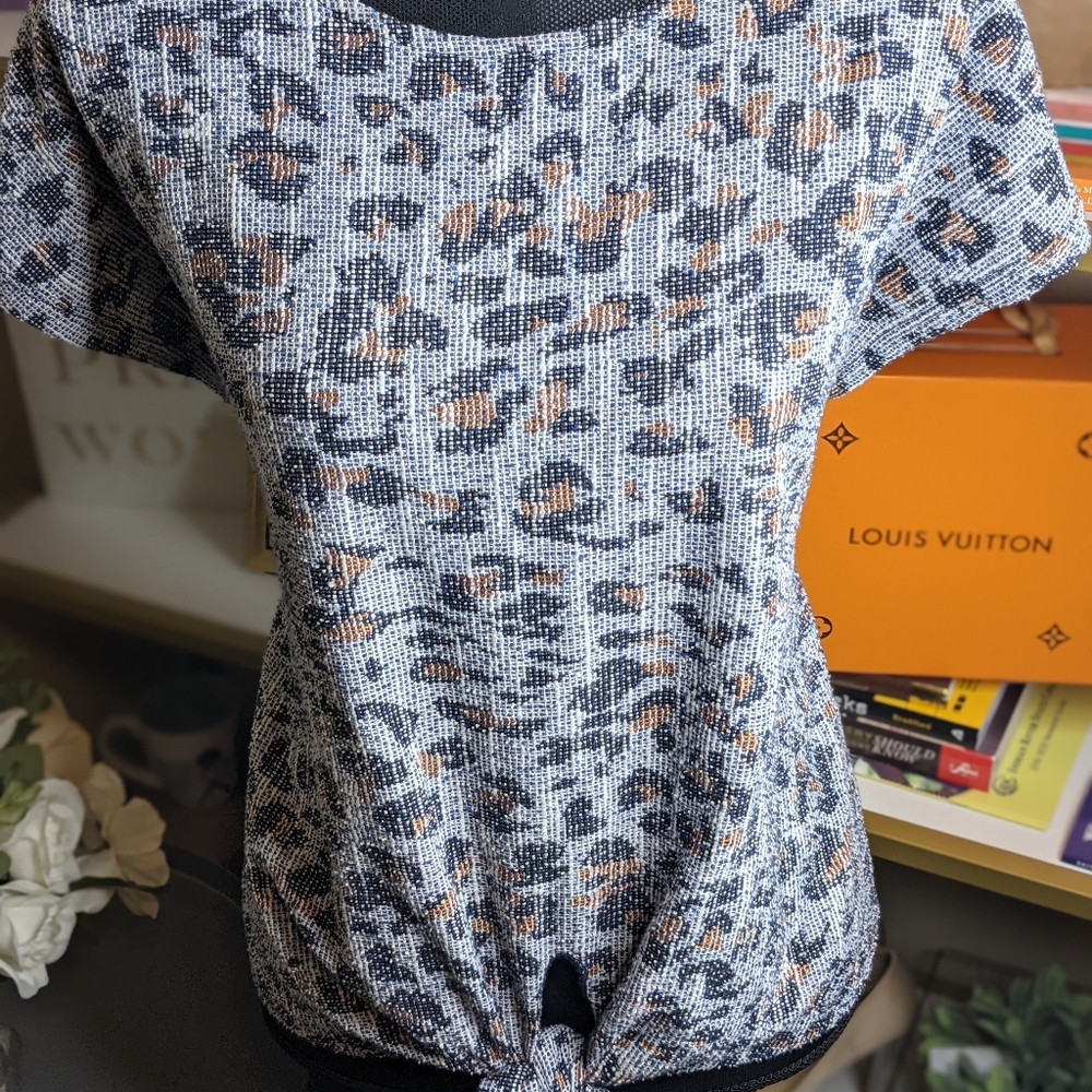 Make an Offer on this beautiful cheetah print top with tie front.
